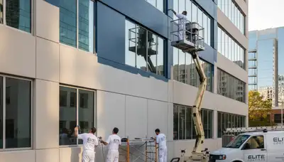 Professional commercial painters finishing office exterior in Tampa, FL for durable, high-quality results