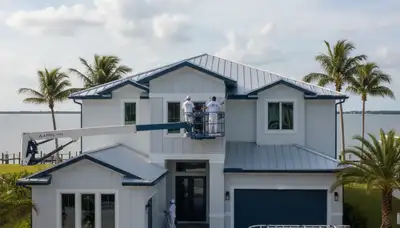 Professional house painters in Tampa FL applying fresh exterior paint to a residential home