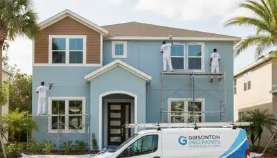 Professional house painters working on exterior home repaint in Tampa, FL
