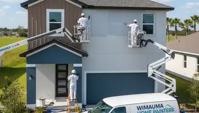 Professional house painters working on exterior home painting in Tampa FL