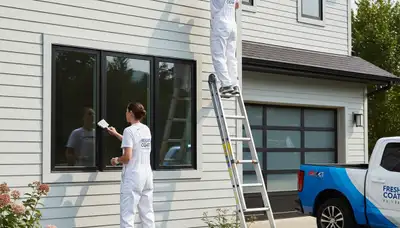 Professional siding painting on a Tampa FL home exterior by experienced local house painters